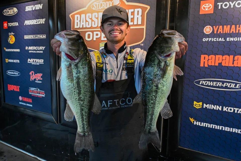 Chase Carey holding two bass